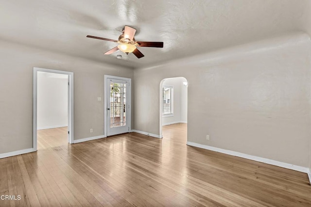 spare room featuring light wood-type flooring and ceiling fan