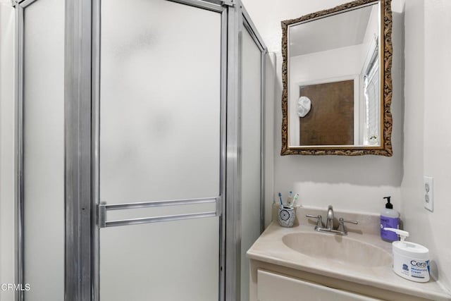 bathroom with walk in shower and vanity