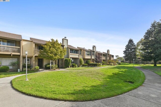 view of home's community featuring a lawn