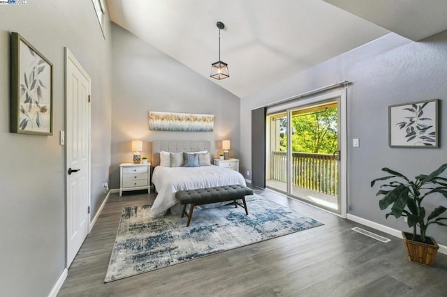 bedroom with dark hardwood / wood-style floors, lofted ceiling, and access to outside