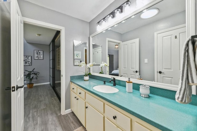 bathroom with hardwood / wood-style floors and vanity