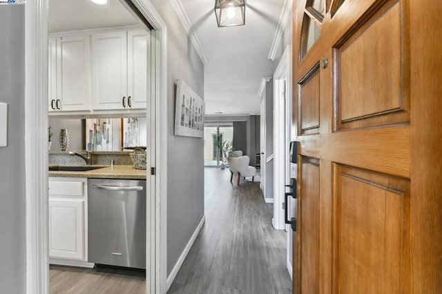 hallway featuring sink, light hardwood / wood-style flooring, and ornamental molding