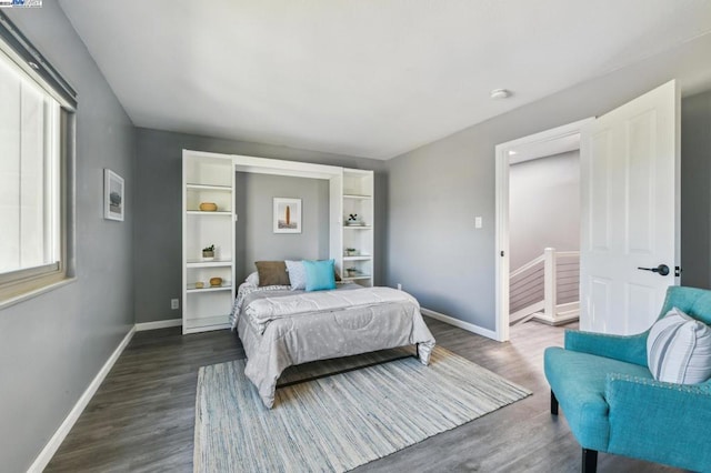 bedroom with dark wood-type flooring