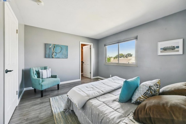 bedroom with dark hardwood / wood-style flooring