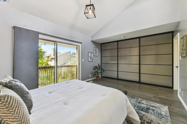 bedroom with access to outside, dark hardwood / wood-style flooring, and high vaulted ceiling