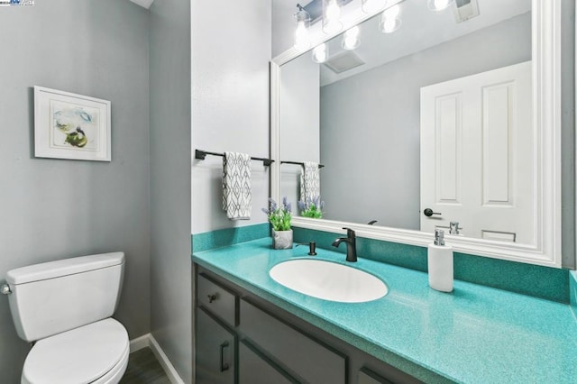 bathroom featuring vanity and toilet