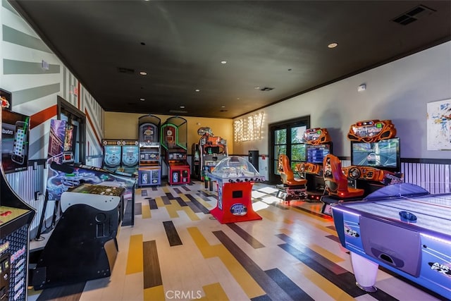 game room with crown molding and hardwood / wood-style flooring