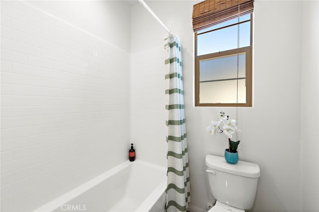 bathroom with toilet and shower / tub combo with curtain