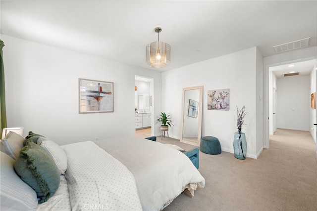 bedroom featuring light colored carpet and connected bathroom