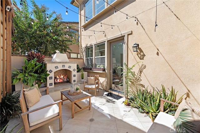 view of patio / terrace with an outdoor fireplace