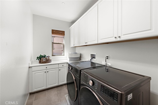 washroom with cabinets, separate washer and dryer, and light tile patterned floors