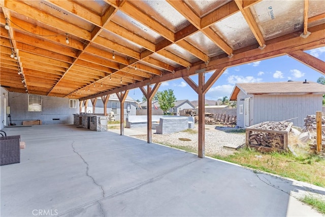 view of patio with a storage unit