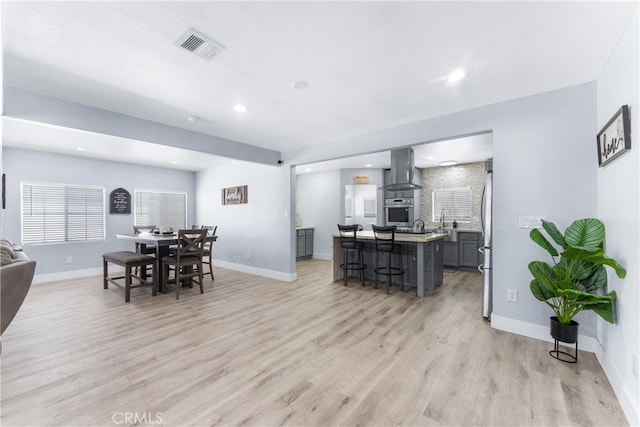 dining space with light wood-type flooring and sink