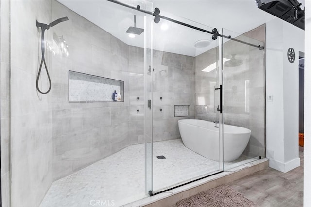 bathroom featuring independent shower and bath and hardwood / wood-style flooring