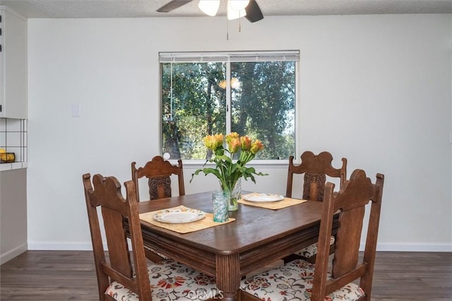 dining space featuring a textured ceiling, ceiling fan, and dark hardwood / wood-style floors