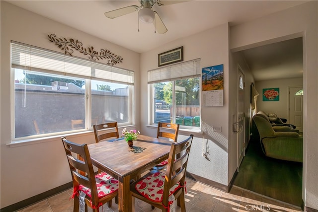 dining area featuring ceiling fan, light tile patterned floors, and a healthy amount of sunlight