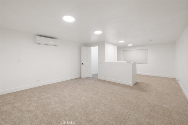 unfurnished room featuring baseboards, recessed lighting, a wall unit AC, and light colored carpet