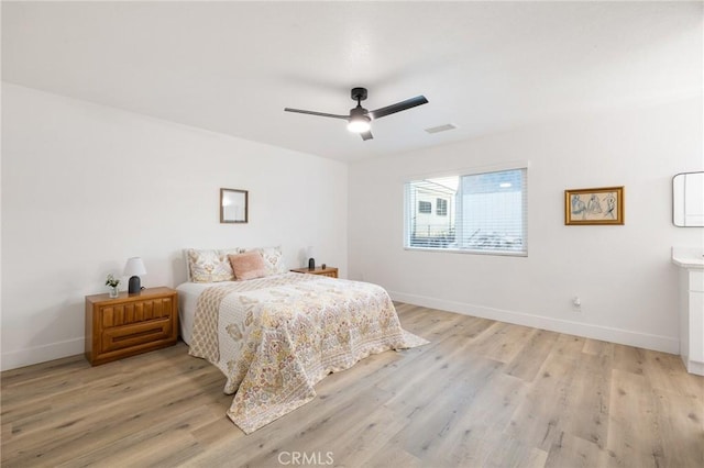 bedroom with visible vents, ceiling fan, light wood-style flooring, and baseboards