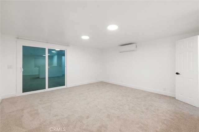 carpeted empty room with a wall unit AC, baseboards, and recessed lighting