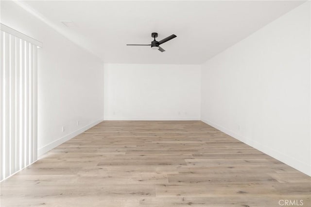 spare room with a ceiling fan, baseboards, and light wood finished floors