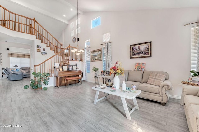 living room with beam ceiling, light wood-type flooring, and high vaulted ceiling