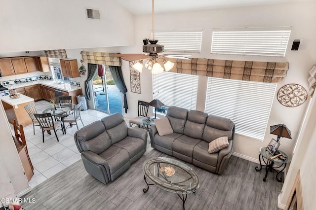 living room featuring ceiling fan and light wood-type flooring