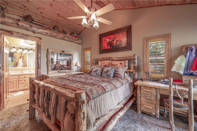 carpeted bedroom featuring ceiling fan, wooden ceiling, ensuite bath, and vaulted ceiling