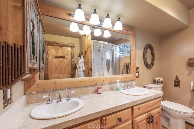 bathroom featuring vanity, toilet, and an enclosed shower