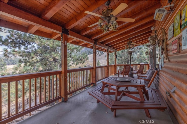 exterior space featuring wood ceiling, lofted ceiling with beams, and ceiling fan