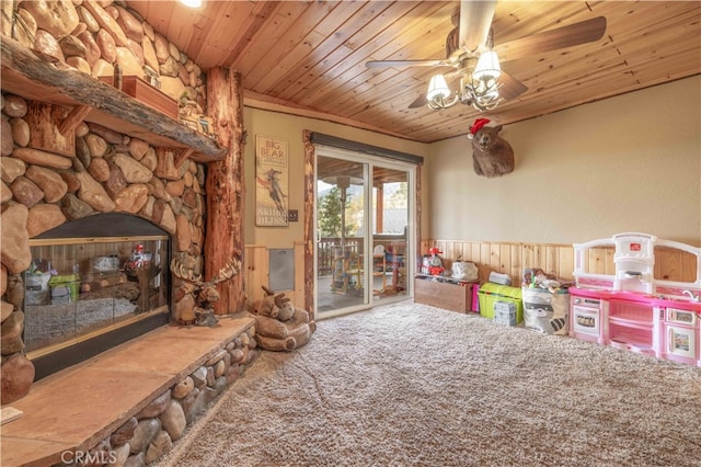 rec room with wood ceiling, ceiling fan, a fireplace, and carpet