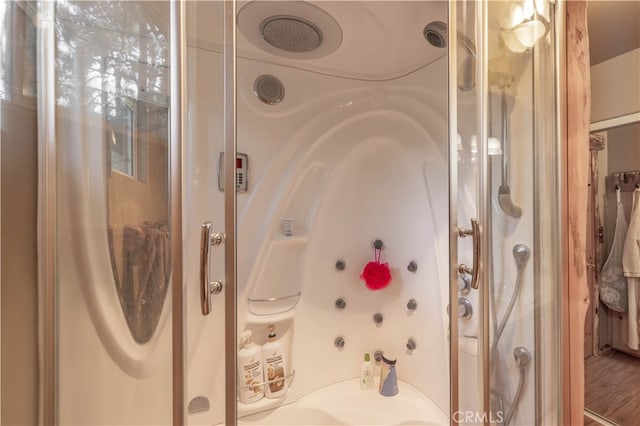 bathroom with independent shower and bath and wood-type flooring