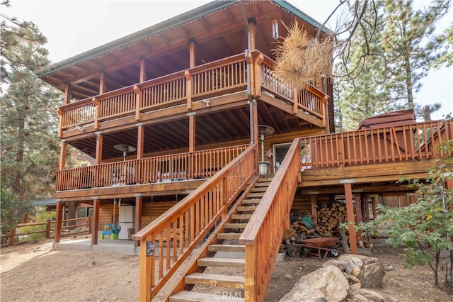 back of property featuring a wooden deck