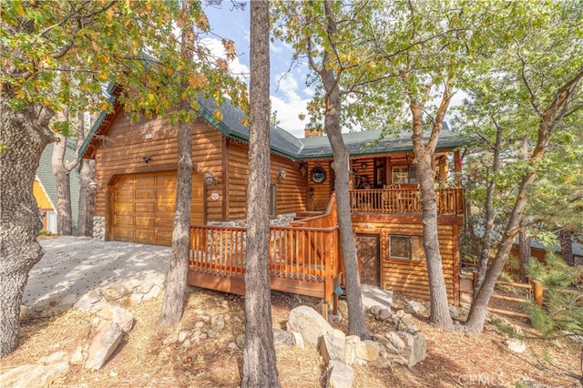 view of front of property with a wooden deck and a garage