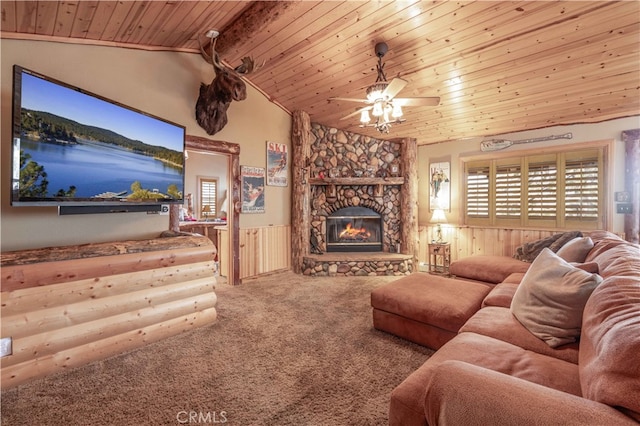 living room featuring wood walls, a fireplace, wood ceiling, carpet floors, and ceiling fan