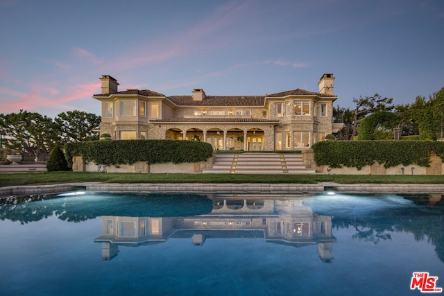 pool at dusk with a yard