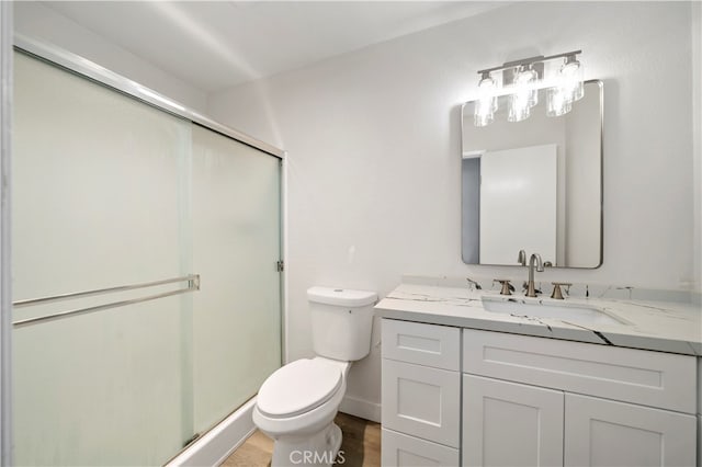 bathroom featuring walk in shower, vanity, and toilet