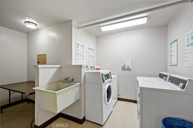 washroom with sink and washing machine and dryer