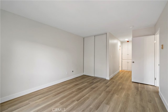 empty room with light hardwood / wood-style flooring