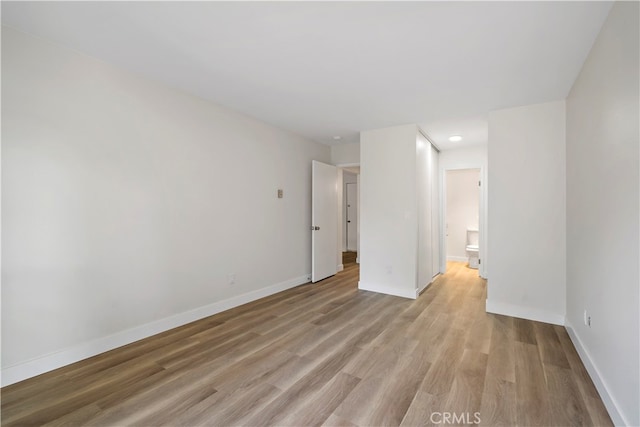 spare room with light hardwood / wood-style flooring