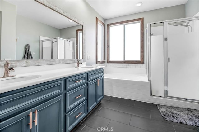 bathroom featuring tile patterned flooring, vanity, and shower with separate bathtub