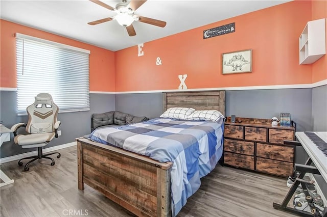 bedroom featuring ceiling fan and wood-type flooring