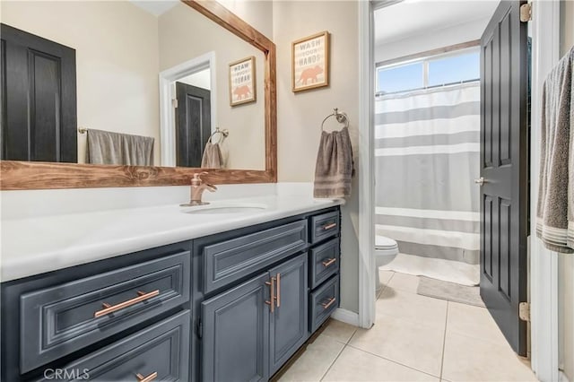 bathroom with tile patterned floors, vanity, a shower with shower curtain, and toilet