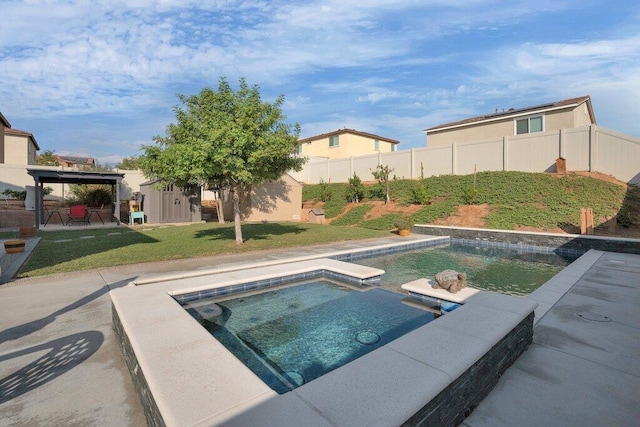 view of pool with a lawn, an in ground hot tub, a patio area, and a gazebo