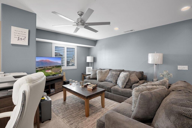 carpeted living room with ceiling fan