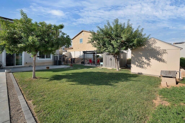 view of yard with a patio and a shed