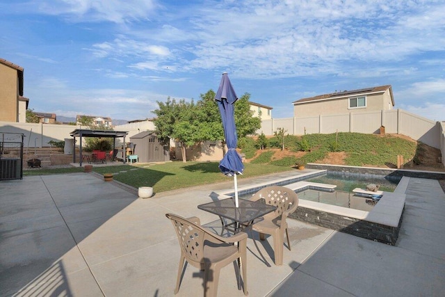 view of patio / terrace with a storage shed, a fenced in pool, and a gazebo