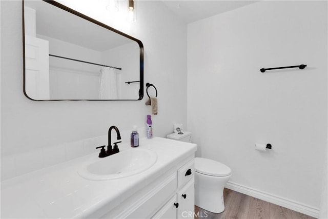 bathroom featuring vanity, curtained shower, toilet, and wood-type flooring