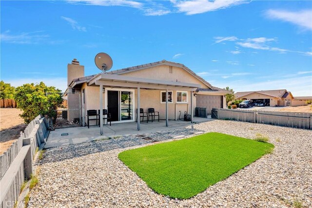 back of house with a patio and a garage