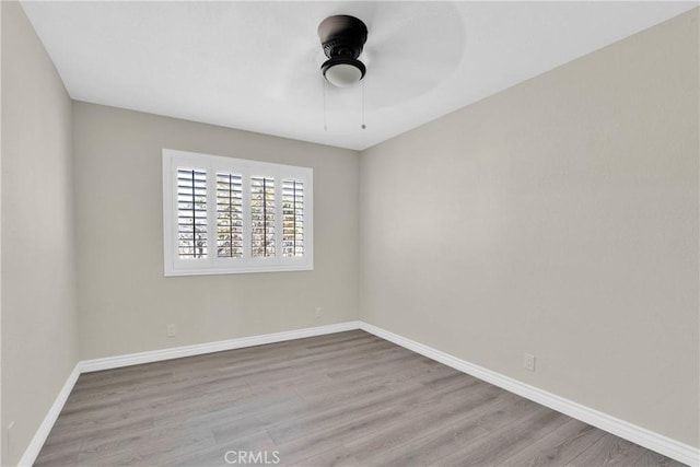 unfurnished room featuring ceiling fan and light wood-type flooring