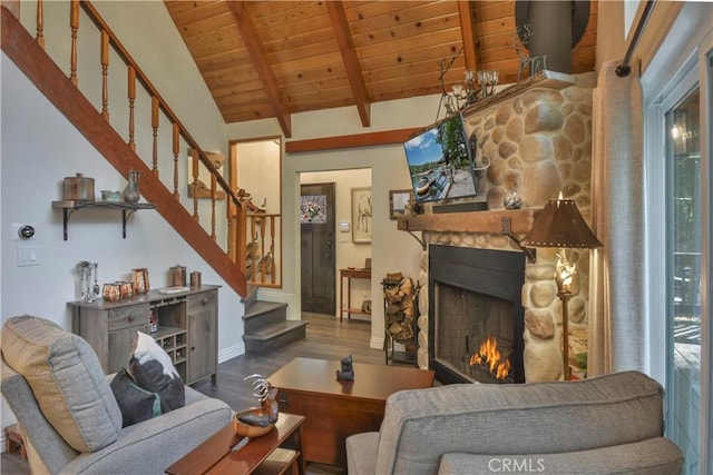 living room with a wealth of natural light, wood-type flooring, lofted ceiling with beams, wooden ceiling, and a fireplace